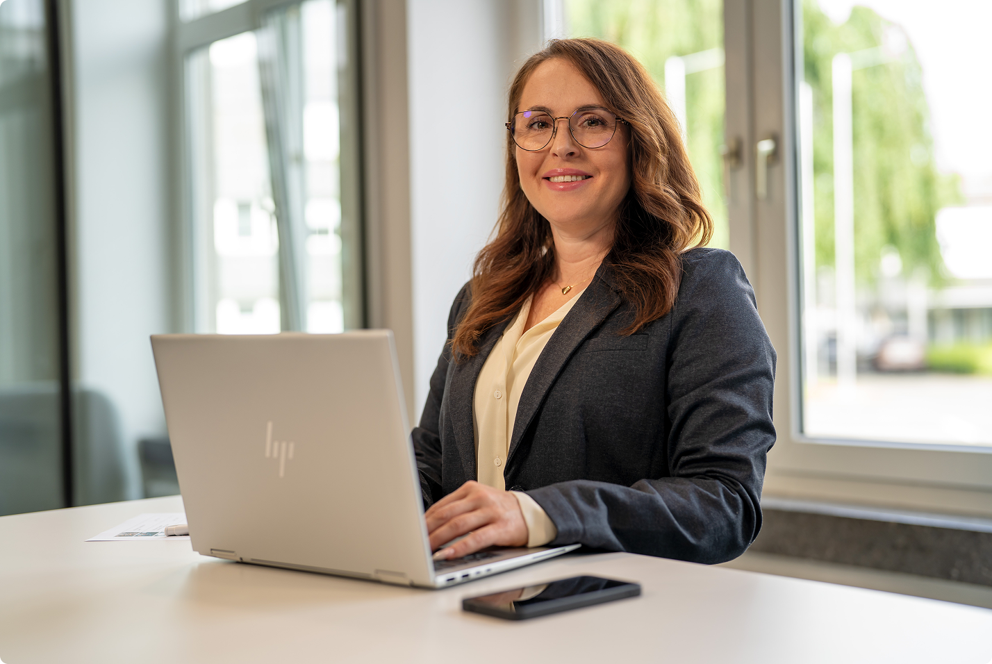 Delta employee working at a laptop in a bright office