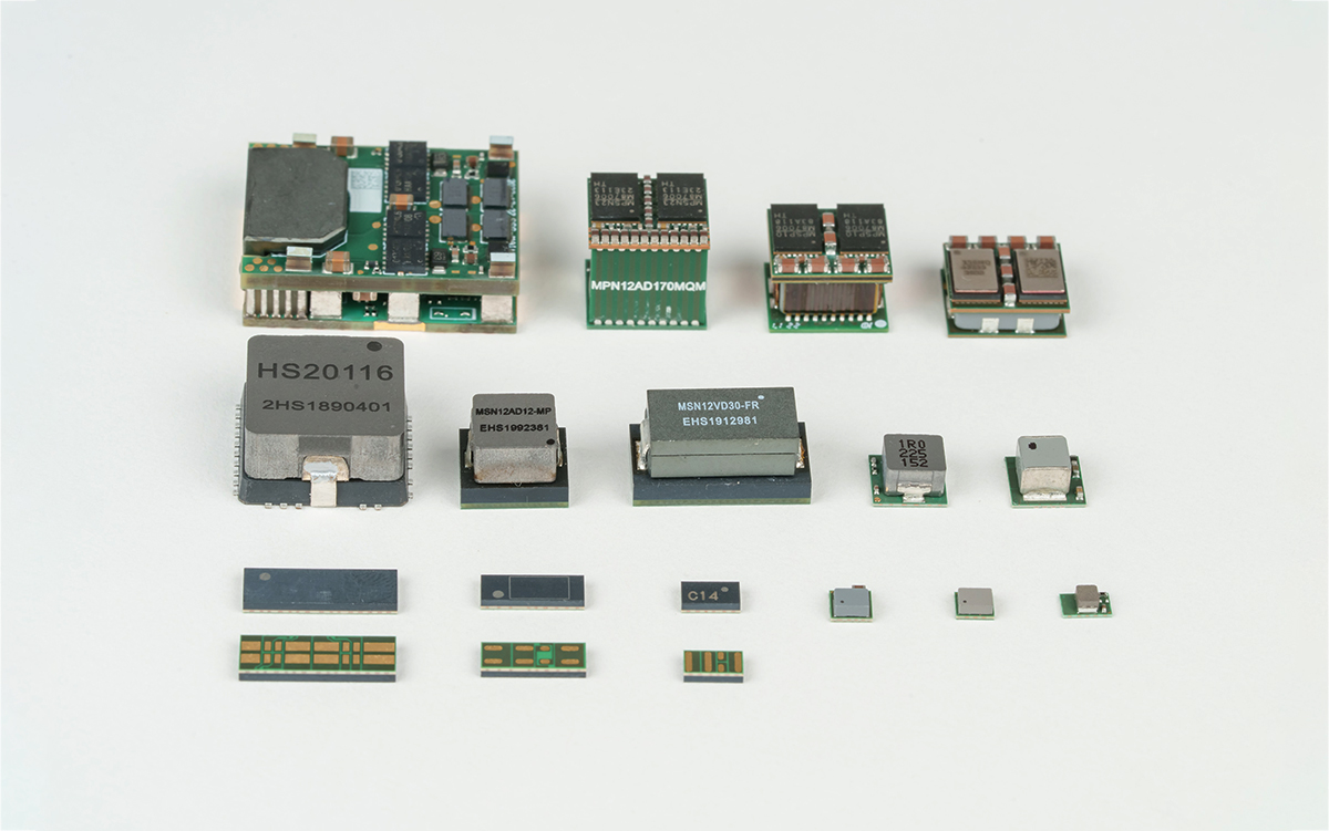 Collection of compact DC-DC converter modules and power components arranged on a light background.